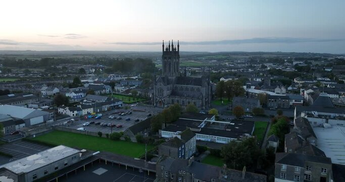Gothic cathedral against the backdrop of a city with one storey houses 4k
