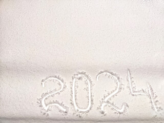 The inscription 2024 in the snow and question mark. Background, texture, frame, place for text....