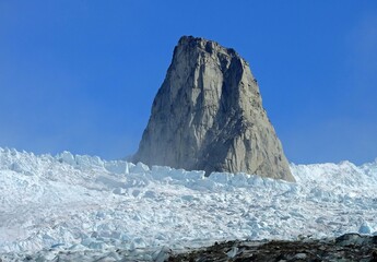 close up of a steep rock spire in the sermeq glacier at the end of the tasermuit fjord on a sunny summer day near nanortalik, in southern greenland