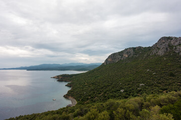 Fototapeta na wymiar Stunning view to the sea from the hills around Toroni village, Chalkidiki, Greece, under a cloudy sky in autumn