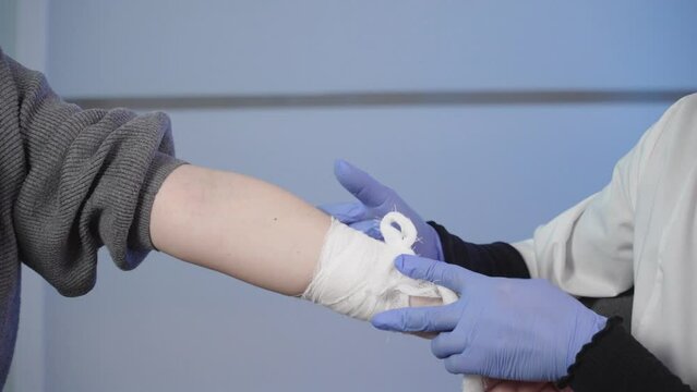 An intern removing a medical bandage