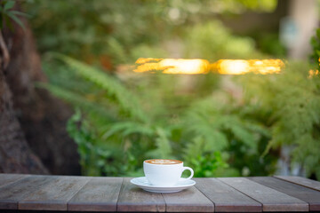 Hot art Latte Coffee. Background Coffee cup and beans on old kitchen table. 