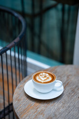 Hot art Latte Coffee. Background Coffee cup and beans on old kitchen table. 