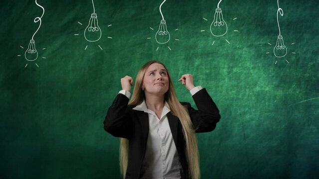 Portrait of woman isolated on green background light bulbs image on top. Girl standing thinking looking up waiting for ideas, no results, lamps without light.