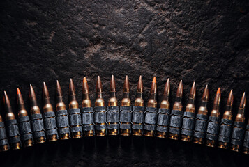 Machine gun bullet belt on the floor. Background on the military theme. Ammo, chain of ammo on...