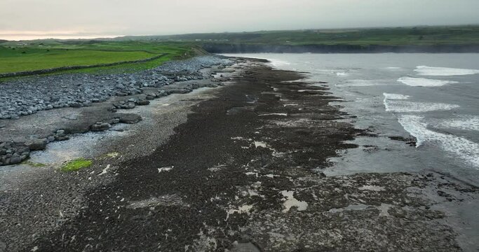 Flying over the stone shore of the Atlantic Ocean in 4k