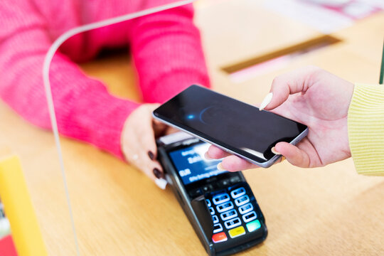Woman making payment through smart phone