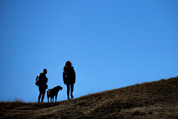 Explorers trek through rugged terrain.