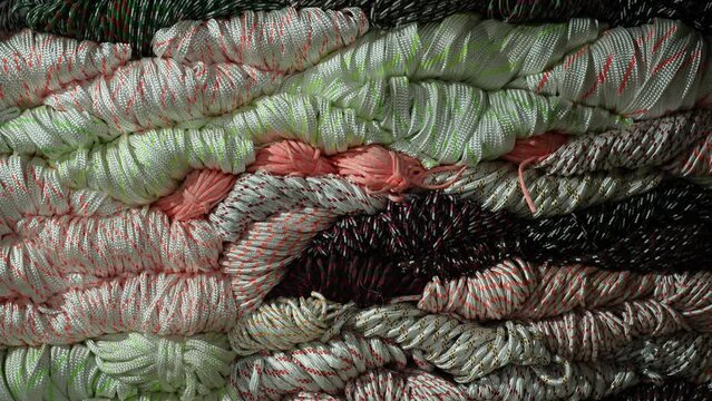 Bright colorful nylon ropes and strings stacked neatly inside a local shop, showing texture, variety, and vibrant retail display perfect for industry, craft, market, and business use