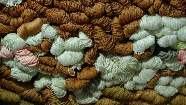 Bright colorful nylon ropes and strings stacked neatly inside a local shop, showing texture, variety, and vibrant retail display perfect for industry, craft, market, and business use
