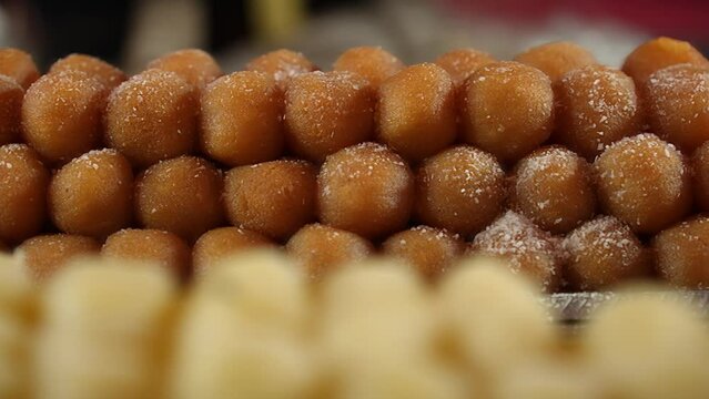 Indian sweet store brims with Rasgulla, Gulab Jamun, and more. Vibrant, aromatic, tempting&mdash;a feast for the senses. Culture and sweetness converge in this delectable, festive display of confectionery