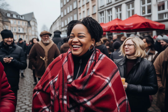 Smiling African American Mature Woman Wrapped In A Blanket Walking Down A Crowded City Street