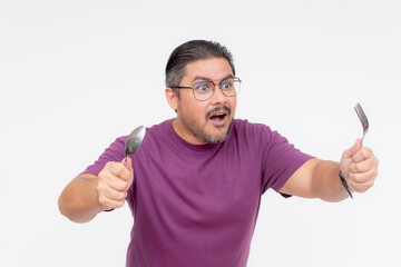 Fototapeta premium A hungry middle aged man holding a spoon and fork chasing something. Restaurant and other food advertisement concepts. Isolated on a white background.