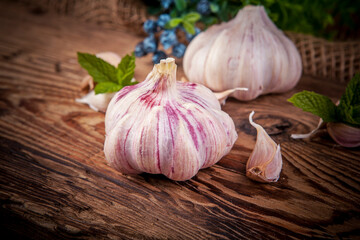 Garlic on a wooden background. Selective focus. Toned.