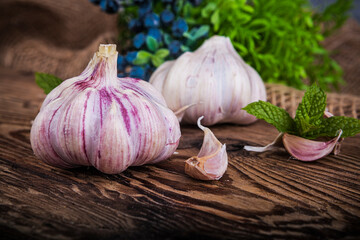Garlic on a wooden background. Selective focus. Toned.