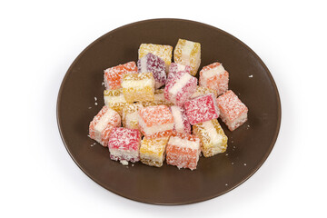 Piece multicolored layered confectionery jelly marmalade sprinkled with flaked coconut