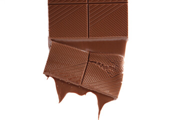 Piece of melted chocolate bar isolated on white background. Chocolate drips.