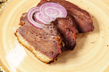 Beef steak close-up with onions. Concept of tasty food. Serving dishes in the restaurant. Selective focus