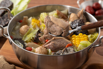 Delicious ginger duck hot pot soup with fresh vegetables in Taiwan.