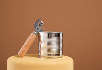 Canned food and can opener with wooden handle. Food preparation.