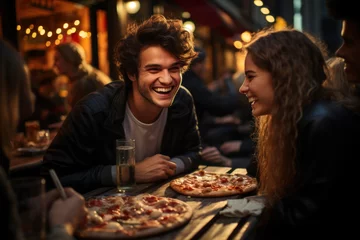 Foto op Canvas Happy young friends eating pizza in a restaurant © sofiko14