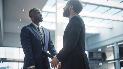 Male Business Partners Meet in Office, Shake Hands. Corporate CEO and Finance Manager Have Meeting in City Office. Businesspeople Came to Discuss Real Estate Purchase and Project. Slow Motion