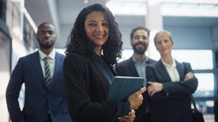 Posing Shot of a Diverse Group of Talented Young Business People Standing in the Modern Office Environment. Successful Team Smiling on Camera, Led by a Confident Female CEO. Slow Motion
