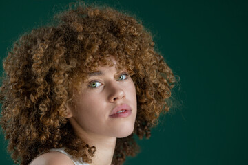 close up portrait of beautiful young woman with curly hair 