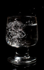 Clean water in a glass on a black background