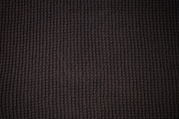 Dark fabric with waves and folds based on PVC.