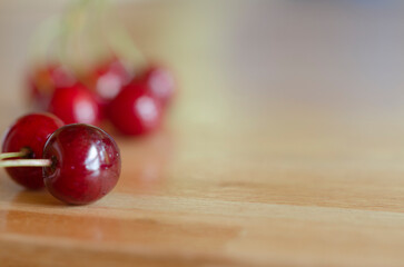 sweet and fresh fruit, red cherries close-up on wooden table and space to fill