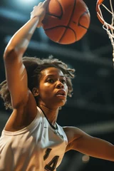 Fotobehang A female basketball player leaping for a slam dunk © Mustafa