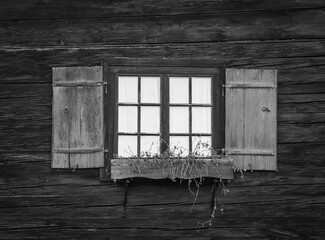 window with shutters of old farmhouse.