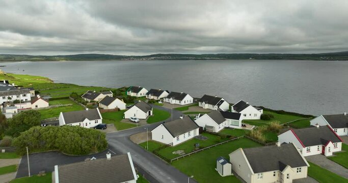 White houses against the ocean on a cloudy day in 4k