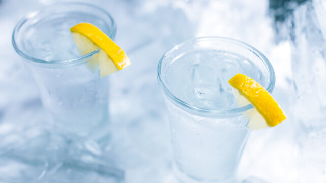 Two glasses of vodka with ice and lemon