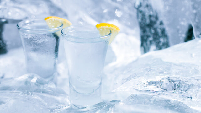 Two glasses of vodka with ice and lemon