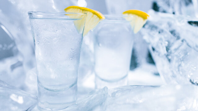 Two glasses of vodka with ice and lemon