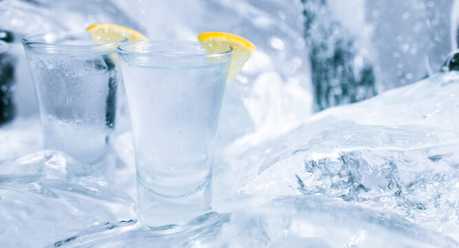Two glasses of vodka with ice and lemon