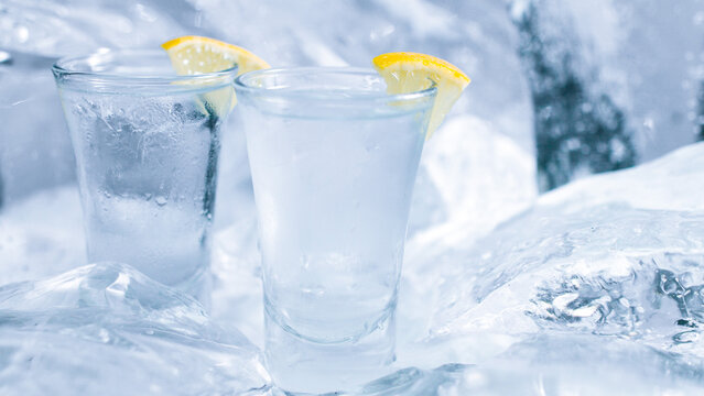 Two glasses of vodka with ice and lemon
