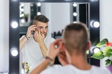 Gay man preparing for drag queen show in the backstage