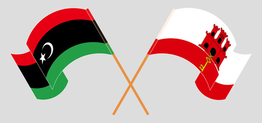 Crossed and waving flags of Libya and Gibraltar