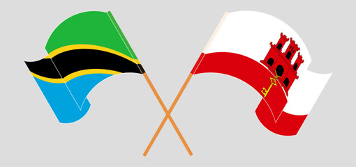 Crossed and waving flags of Tanzania and Gibraltar