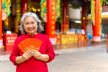 Chinese lunar new year festival and tradition holiday celebration concept. Happy Asian senior woman...