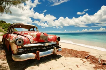 Fotobehang A vintage car slowly rusting away on a beach. © Nicole