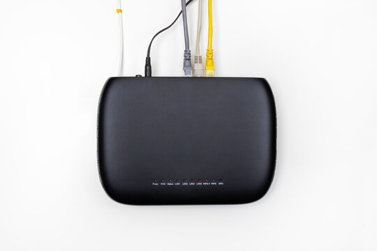 black gpon subscriber terminal with connection to a fiber optic Internet network and various devices with lan cables on a white background top view