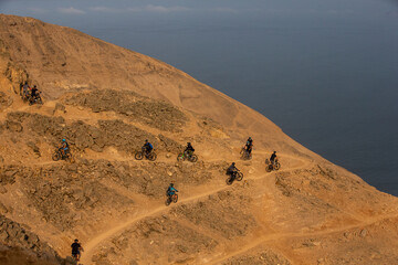 Fototapeta na wymiar Enduro bikers challenging the lines at el Morro Solar Chorrillos Lima Peru