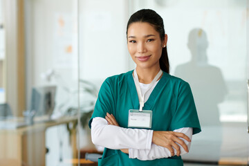 Portrait of young smiling nurse of rehabilitation center in scrubs