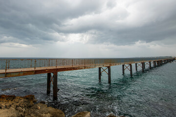 Wooden pier by the sea. Pier by the sea made of iron. Wooden pier by the beach.
