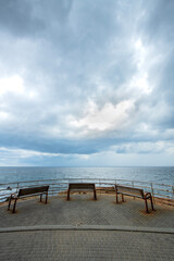 Fototapeta na wymiar Empty bench by the sea. Cyprus. A bench on the coast, by the sea. 