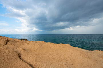 Looking at the sea from the coastal green area. Looking at the sea from the rocks on a cloudy day....